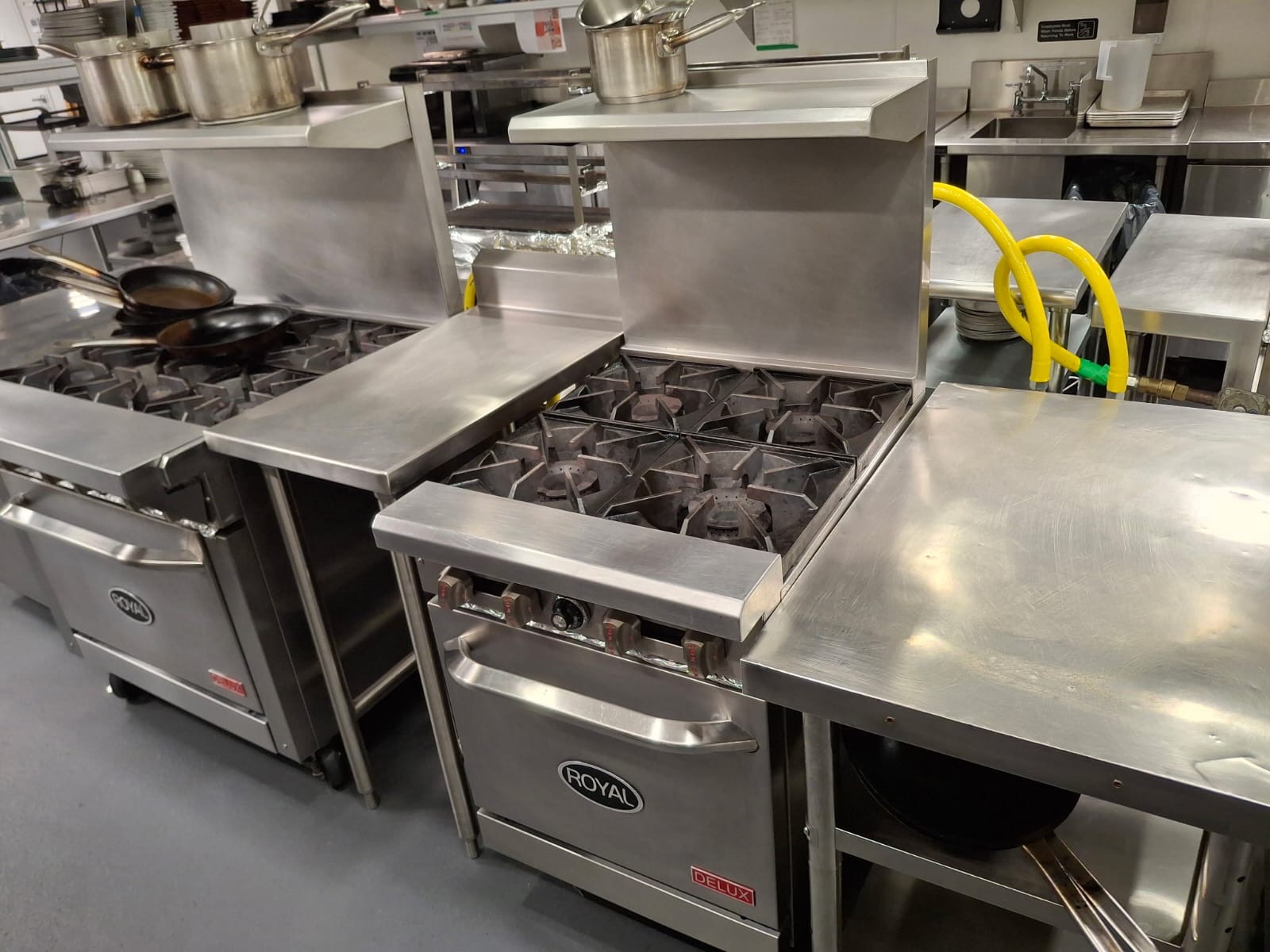 Commercial kitchen cookline degreased and stainless prep surfaces sanitized by Ledian's Cleaning Services