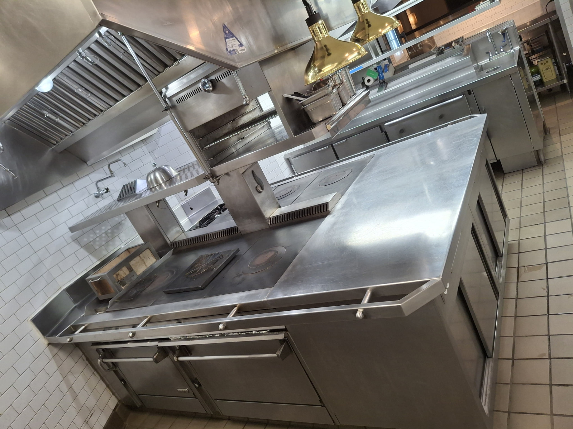 Cleaned restaurant cook line with degreased range hood and stainless surfaces — Ledian's Cleaning Services