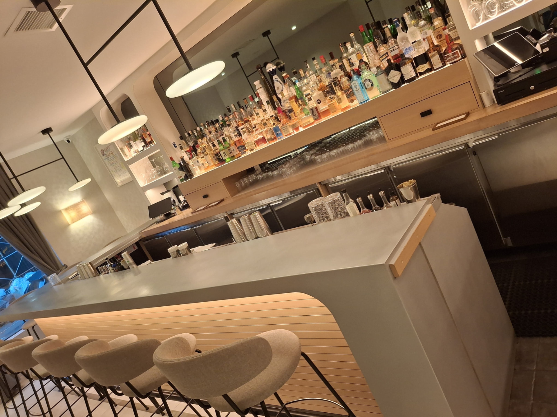 Restaurant bar with wiped-down bar top and organized bottle display — Ledian's Cleaning Services